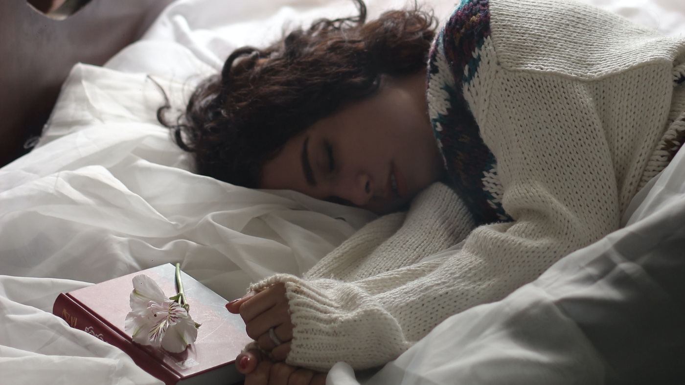 Burned out woman laying in bed