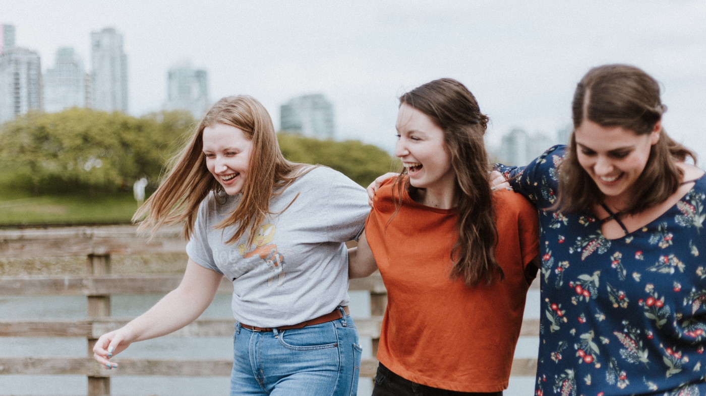 Friends laughing and walking outside
