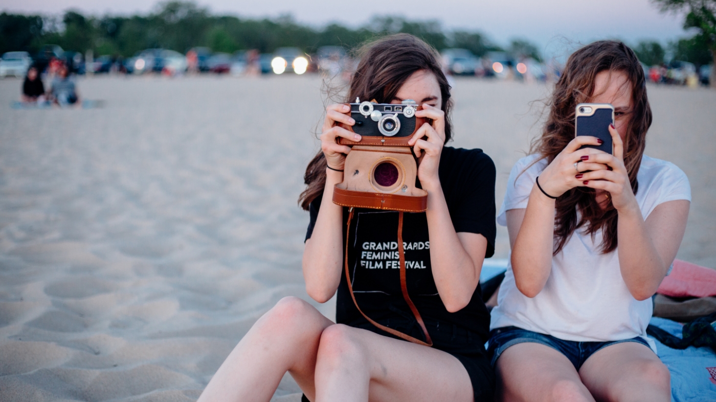 Girls practicing photography at the beach