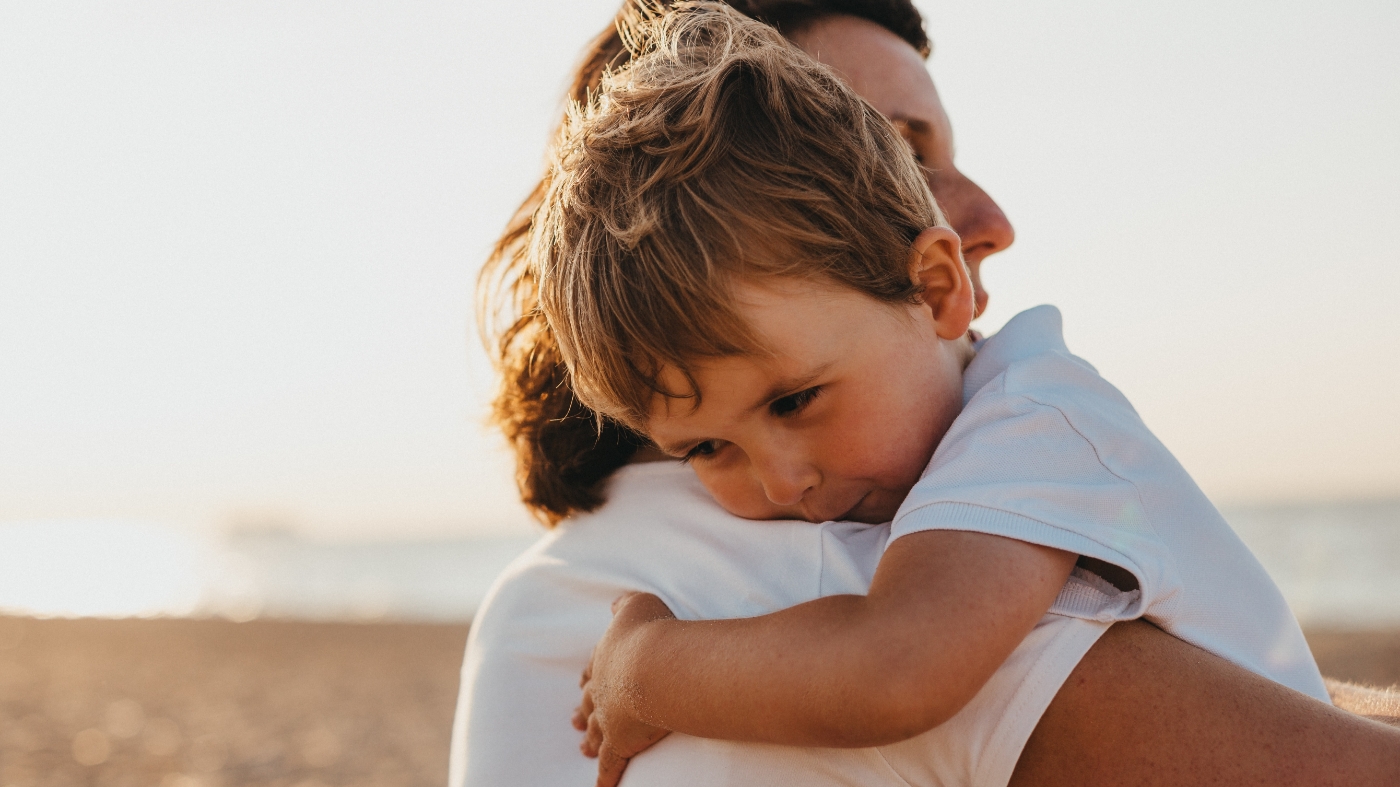 Mom hugging and connecting with her son while he is upset