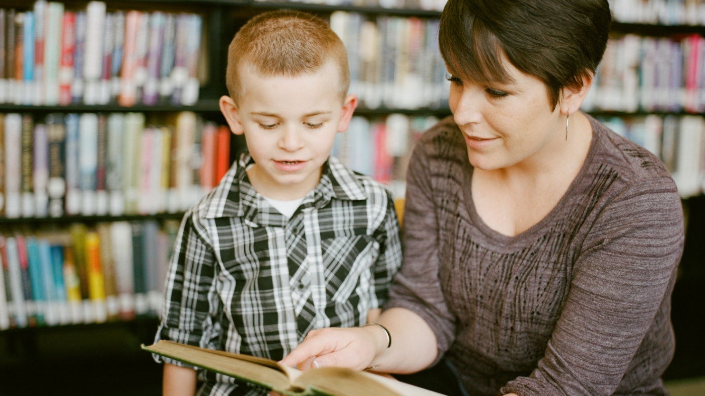 Kids Ministry teacher reading to a boy