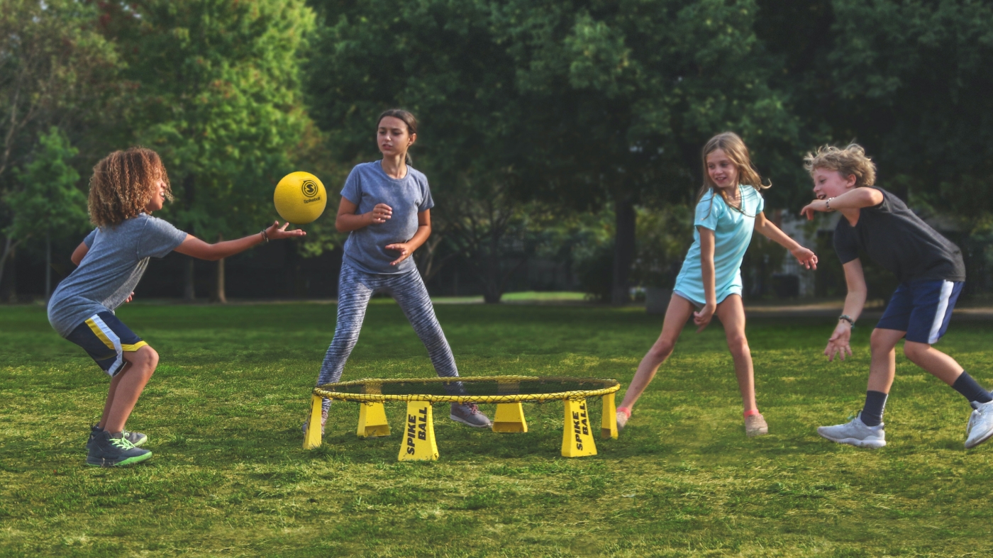 Six to ten year olds kids playing with a ball