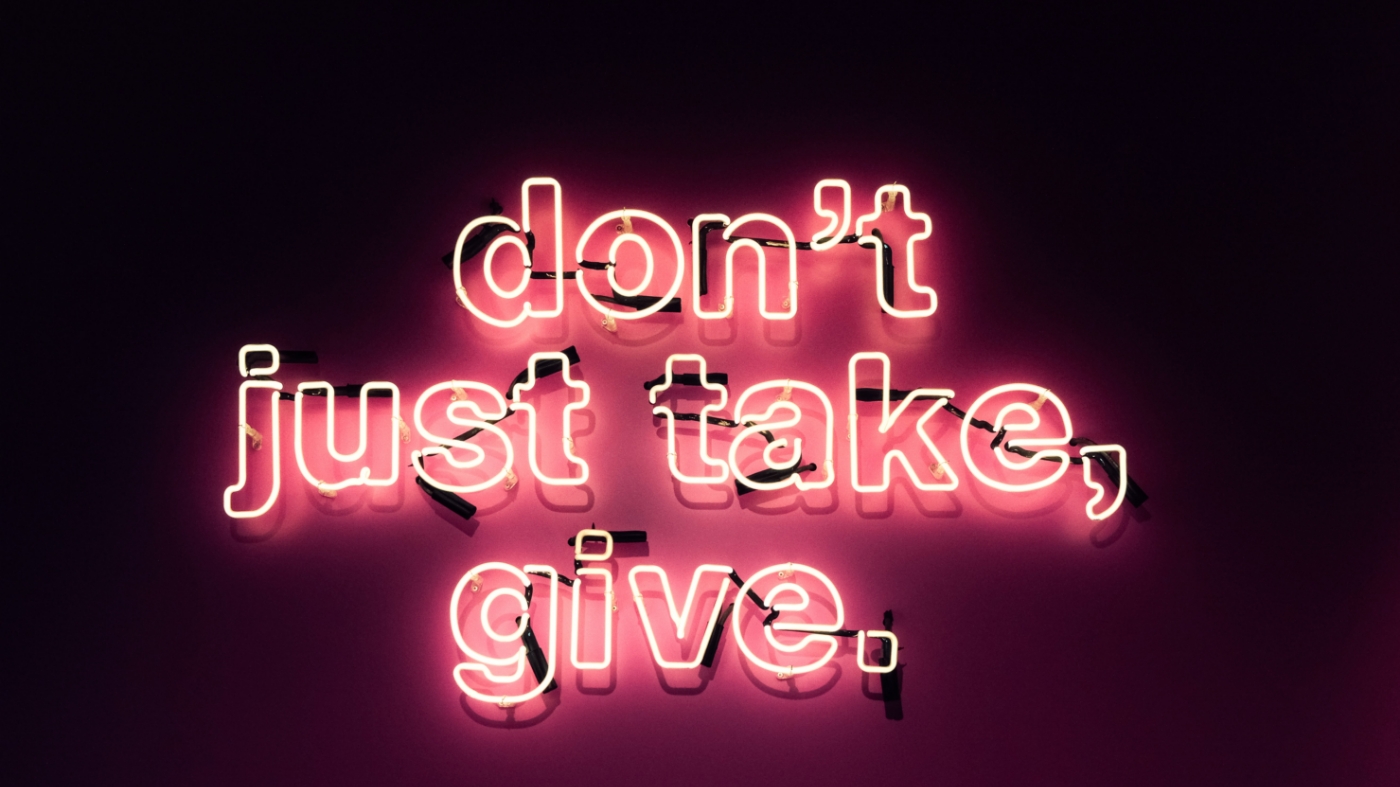 Sign reading, "Don't just take, give."