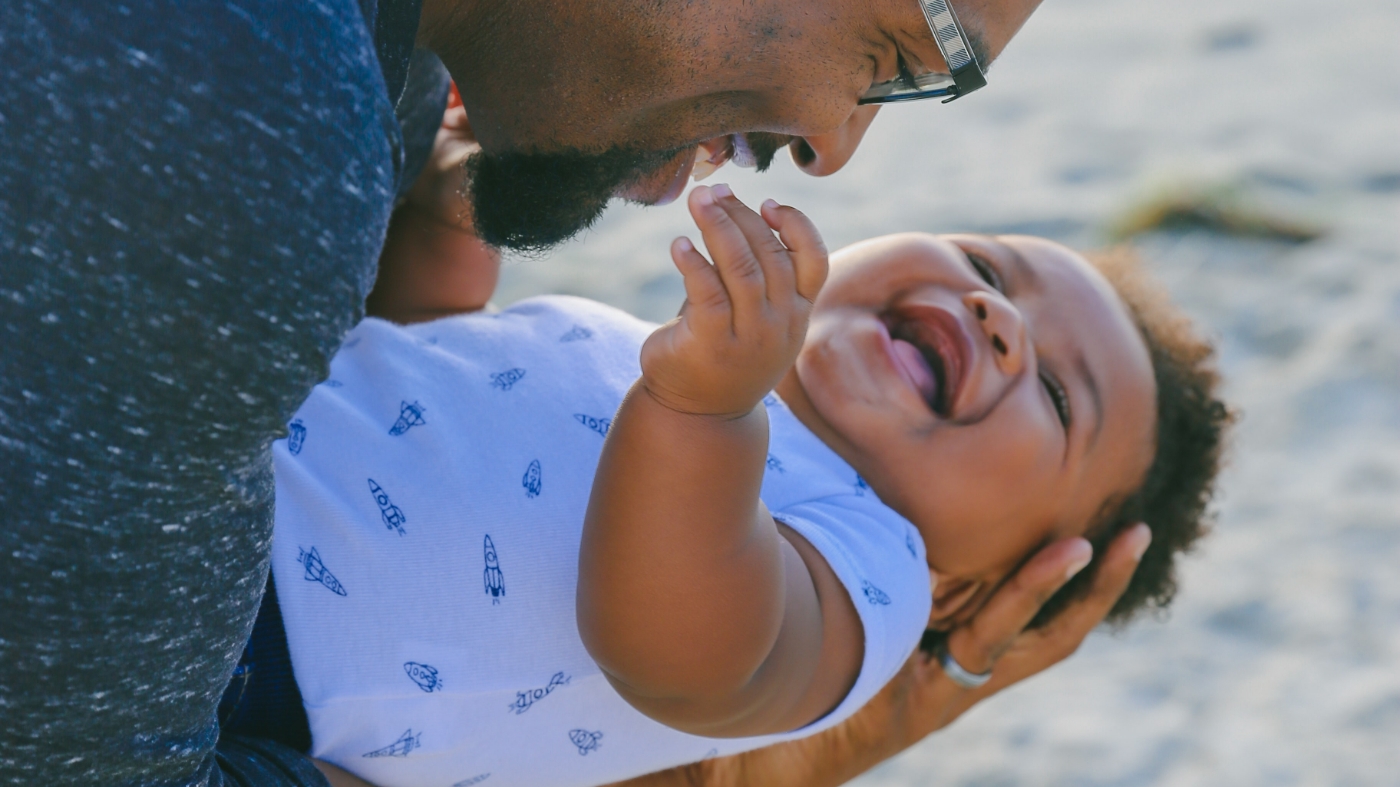 Parent laughing and smiling with his son