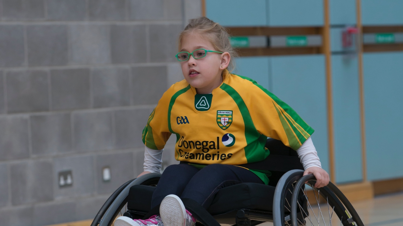 Child on wheel chair playing a game