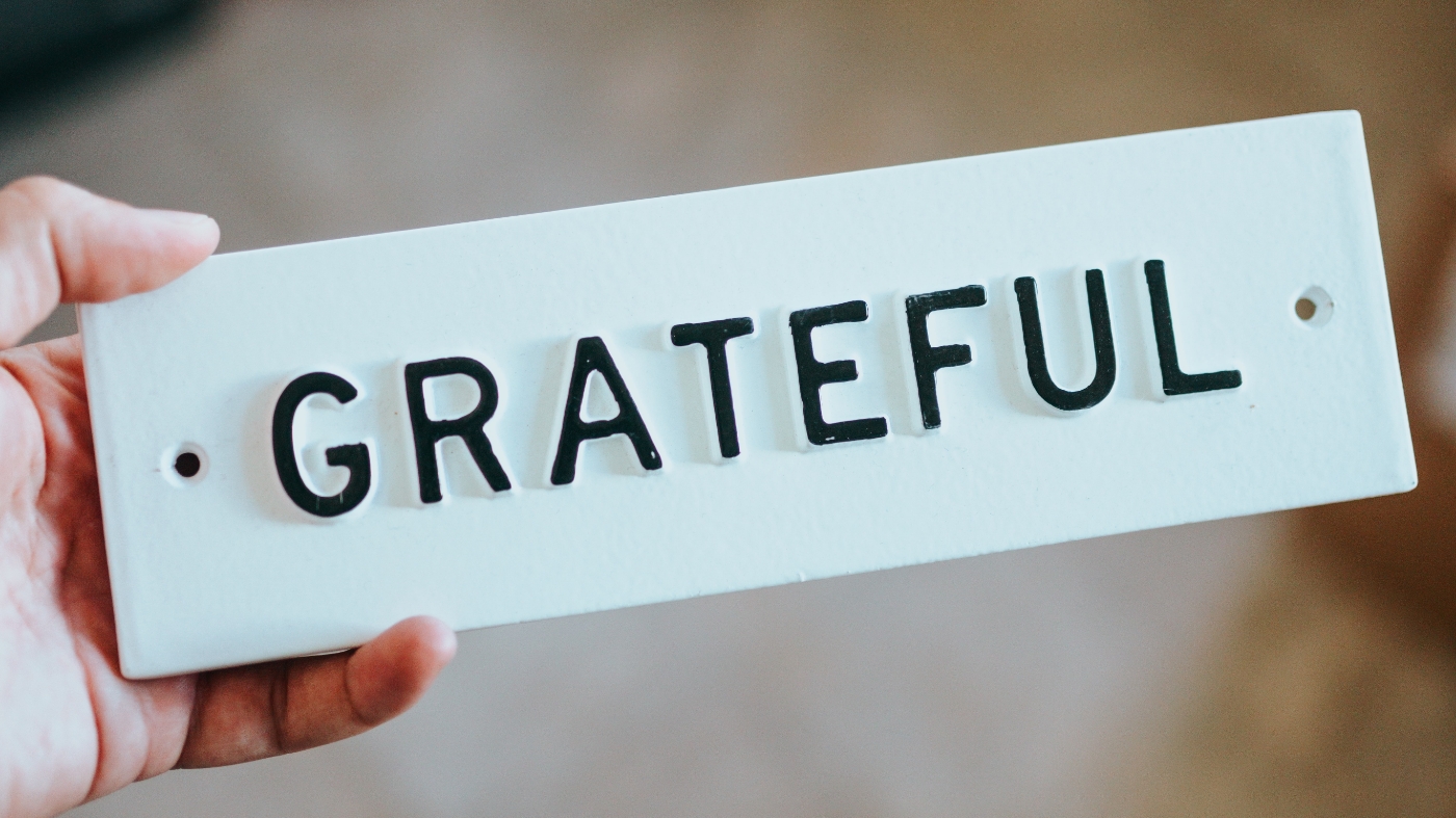 Holding a grateful sign