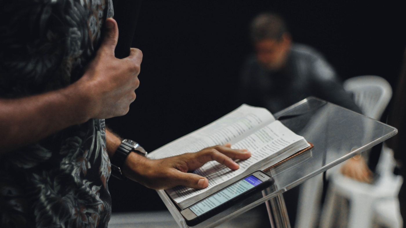 Pastor reading the bible and preaching