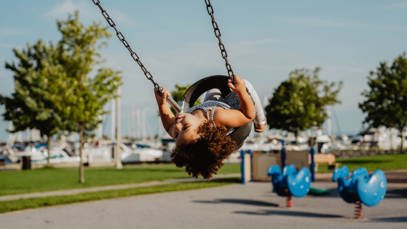 Girl having fun on the swings
