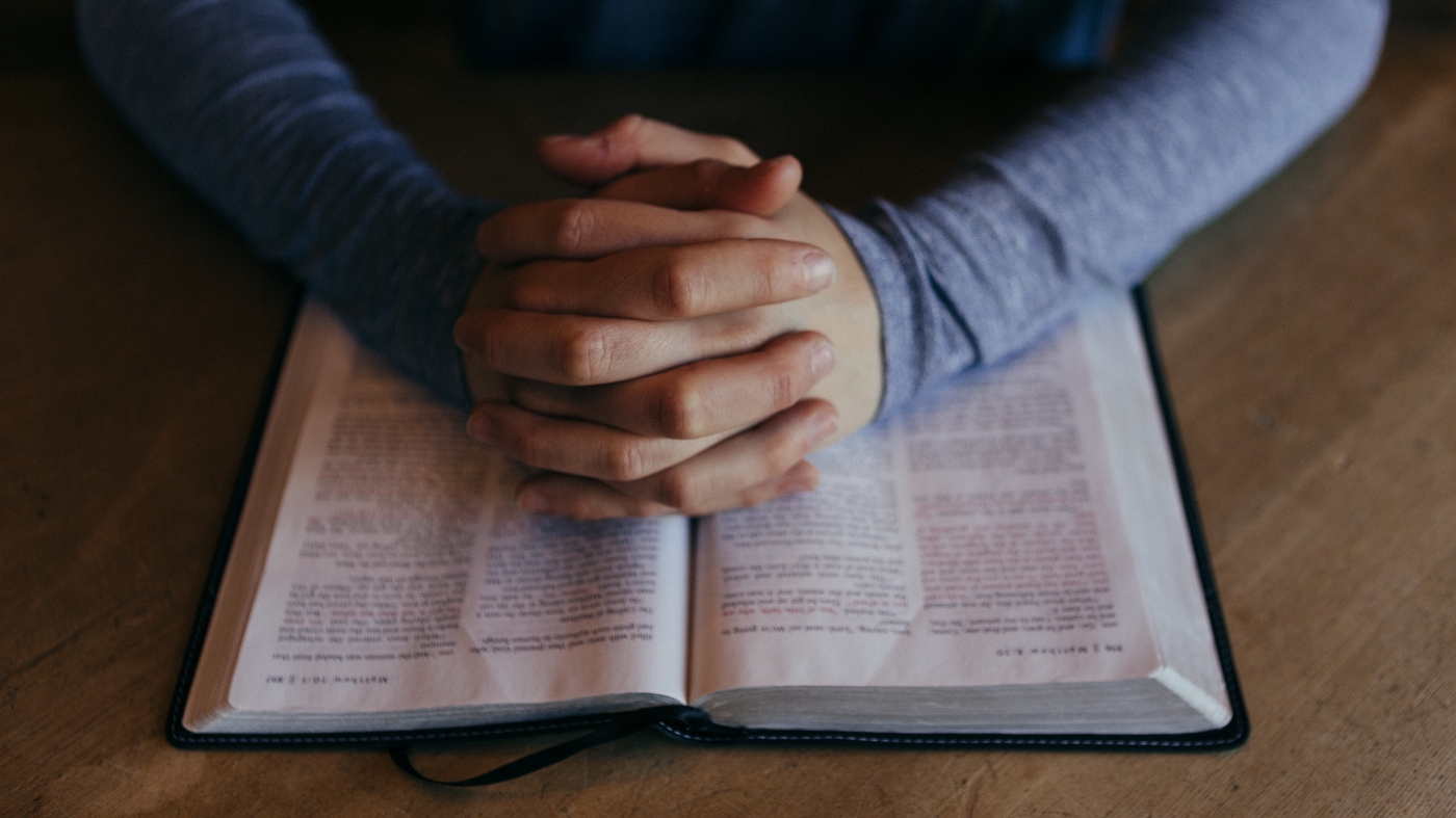 Man praying and reading bible