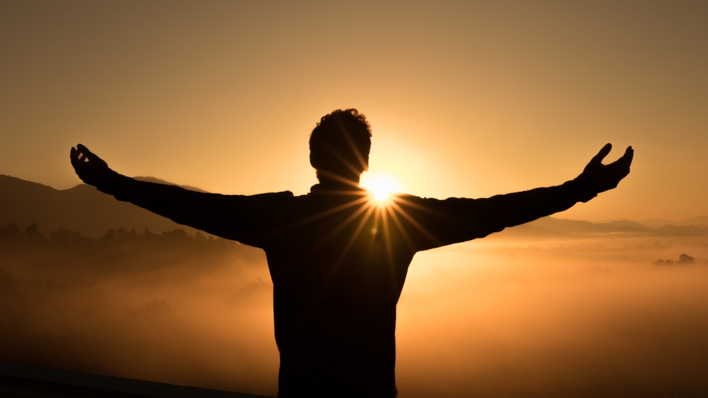 Man waking up to a beautiful sunrise and feeling Gods presence