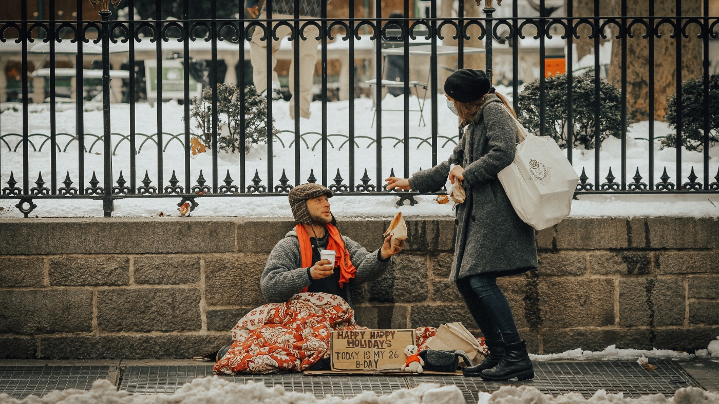 Giving food to a homeless man