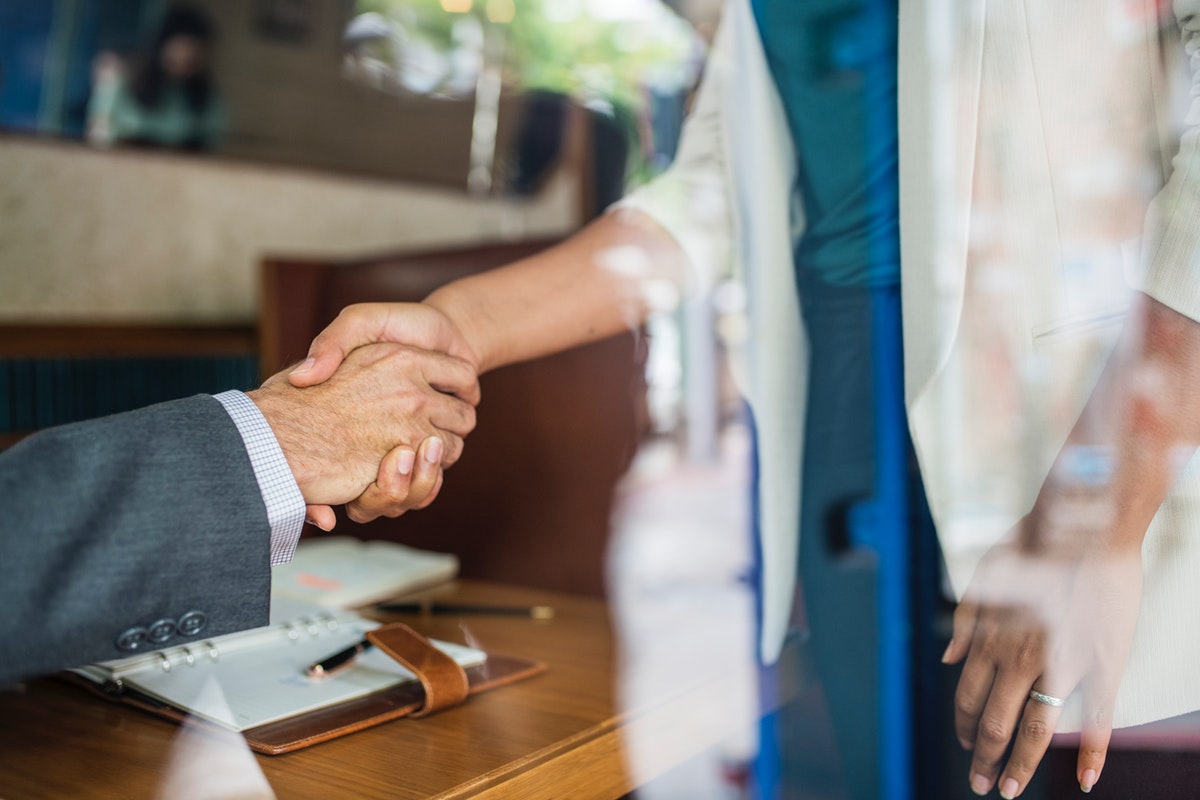 Photo of two people shaking hands