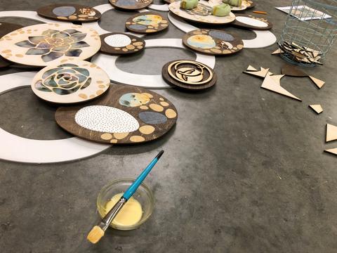 the process of gluing all the pieces of the backdrop in place