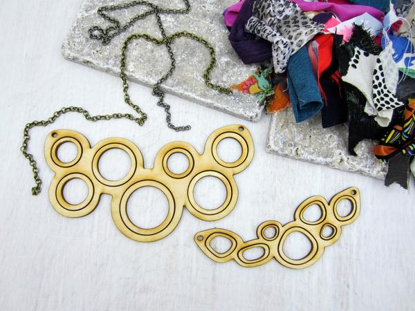 DIY Necklace Workshop, empty wood necklaces with a pile of fabric