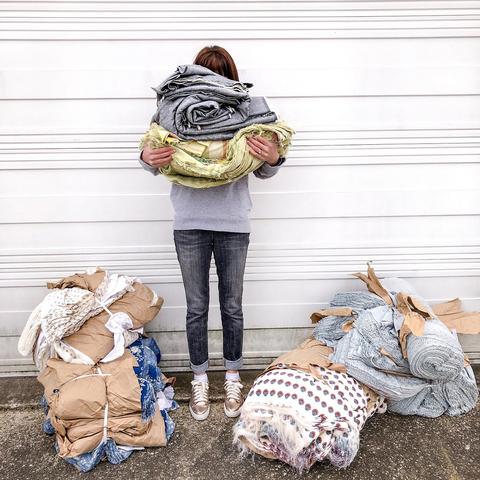 Alyssa Holding bundles of fabric from L.A. clothing manufacturer