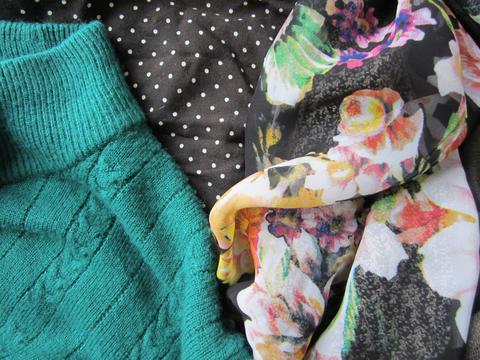 Colorful floral print, teal sweater knit, black and white polkadot print.