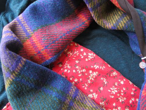 Red fabric with floral print, teal sweater knit, and colorful wool plaid.