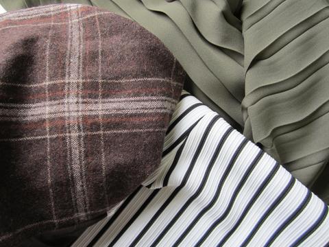 Brown wool plaid fabric, black and white stripe, forest green pleated chiffon fabric.