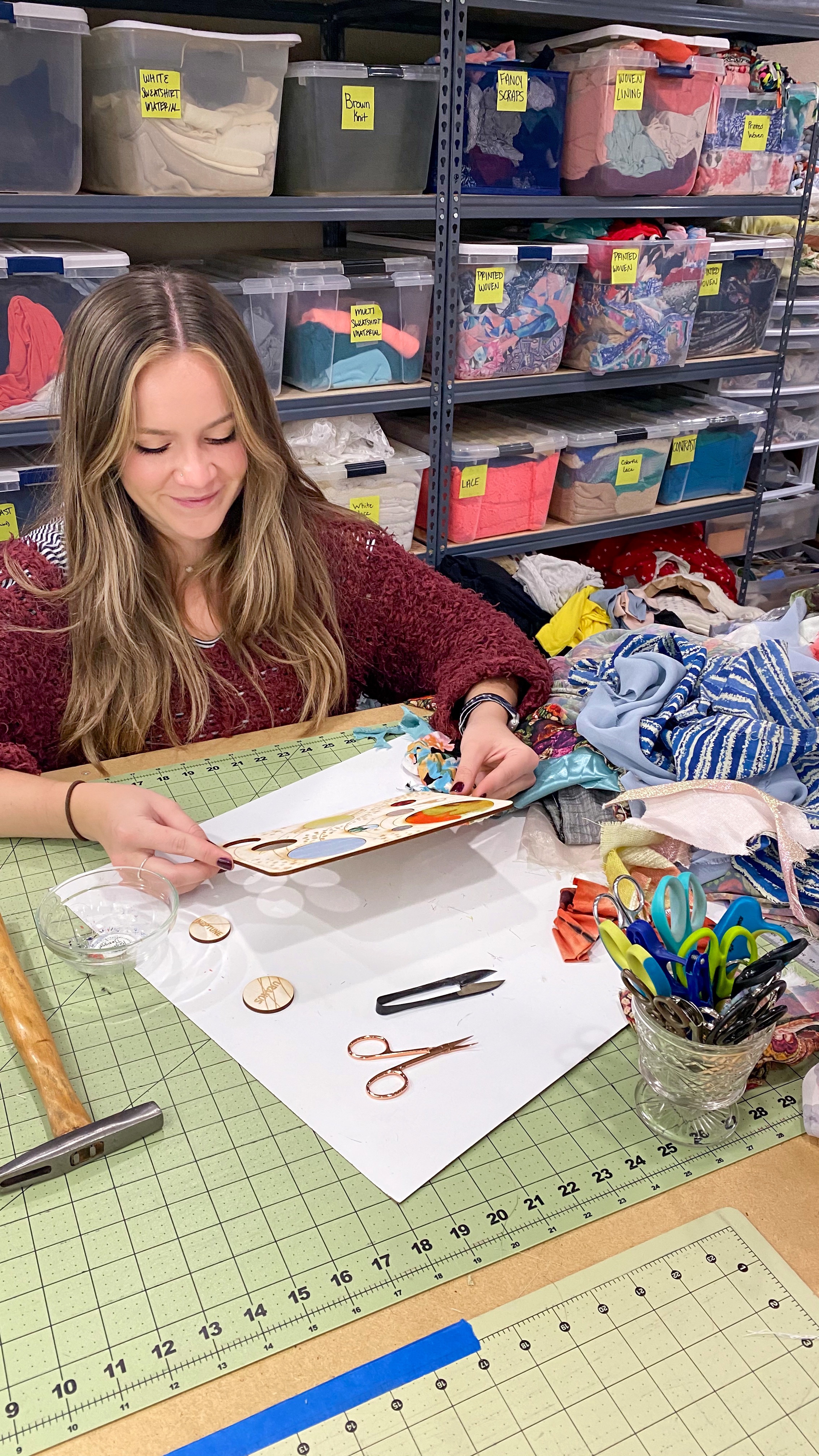 Intern Cassidy Dutton working on her DIY educational art kit craft project for kids - textile and wood solar system space galaxy planets astronaut