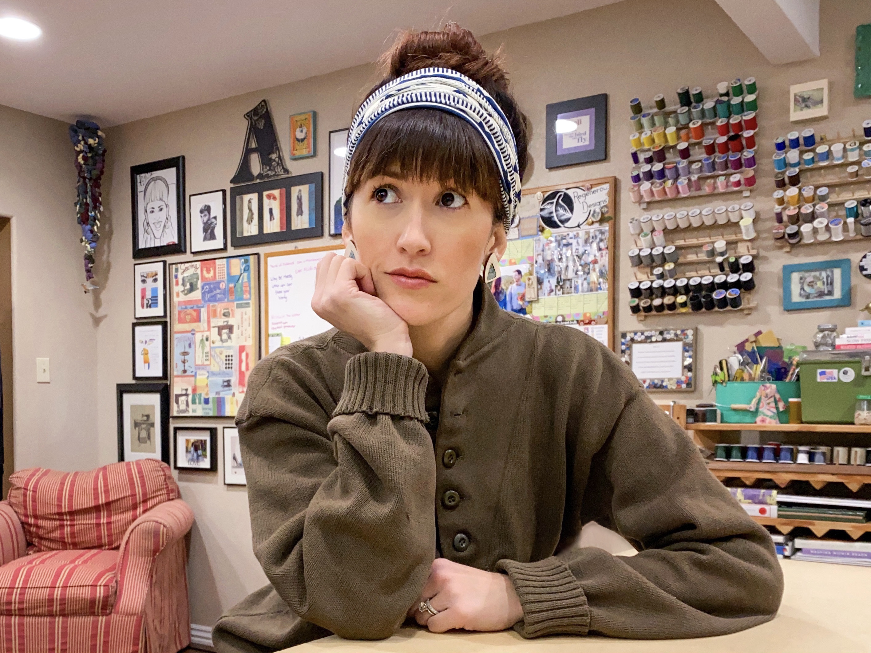 Alyssa Bird sirring at her work table with a worried look on her face