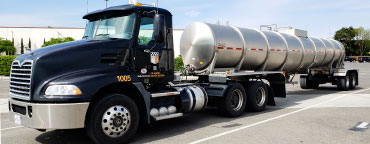 A parked bivio logistics Mack Truck with a large wine trailer
