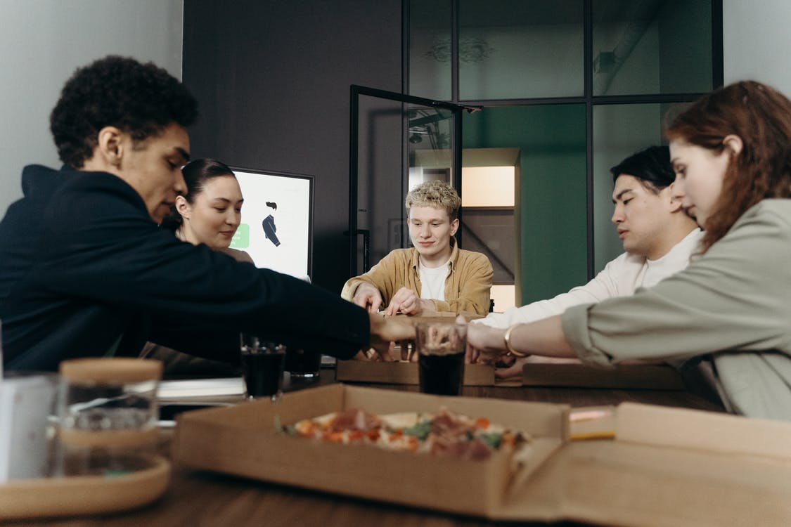 People Eating Pizza in the Office