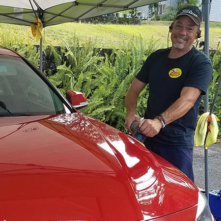 Steven working on a car's exterior on the Big Island