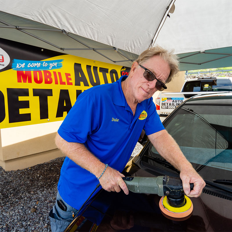 Steven working on a car's exterior on the Big Island