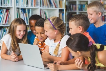 Kids playing with a donated laptop