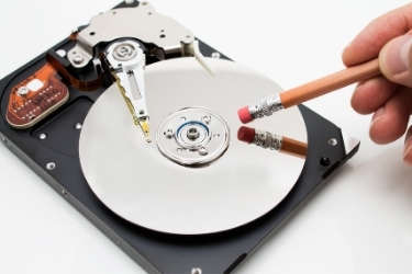 Erase Data Concept - Eraser near a hard disk