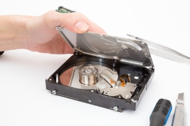 Hand disassembling a hard drive