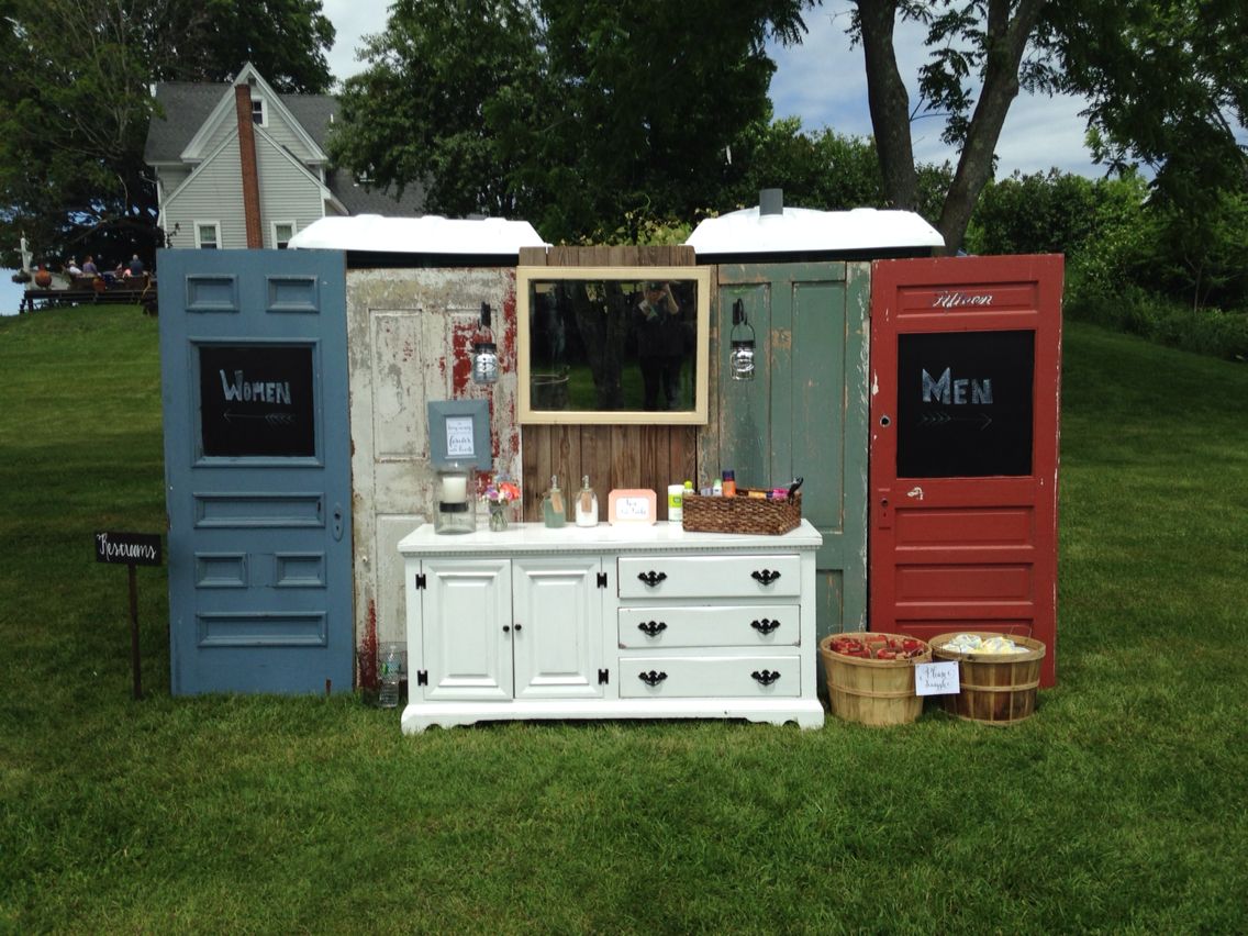 rustic doors and a cabinet covering up two porta potties