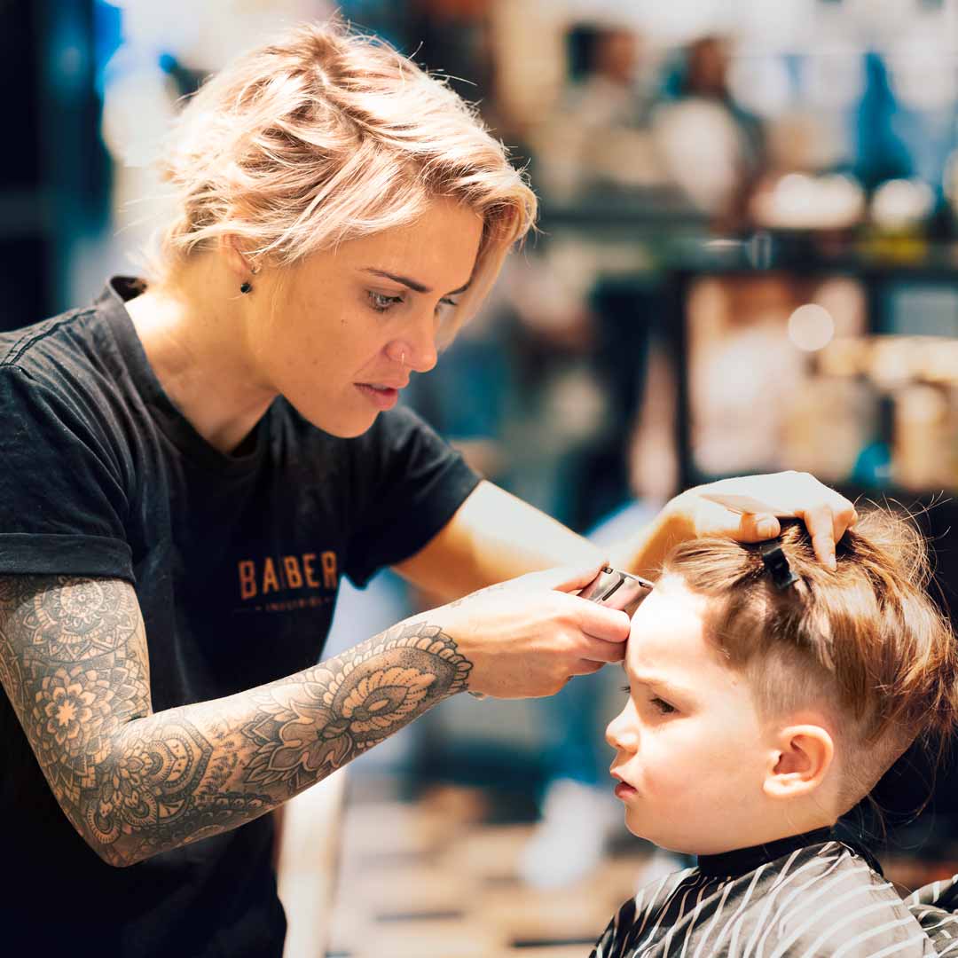 Lady Barber Cutting Childs Hair