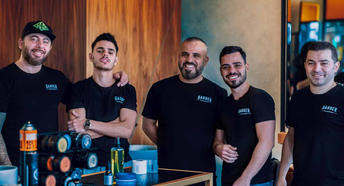 Team of Barber line up for group photo in the Barbershop