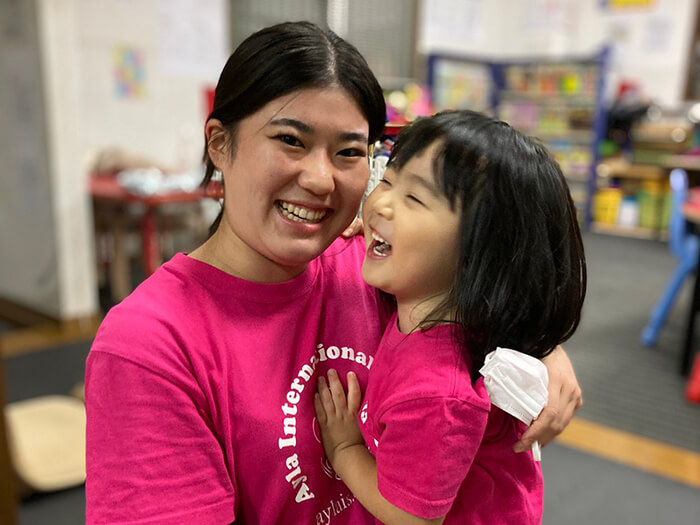 Student laughing with teacher.