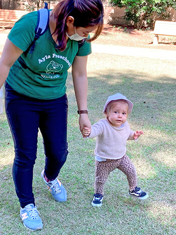 Student walking outside with teacher.