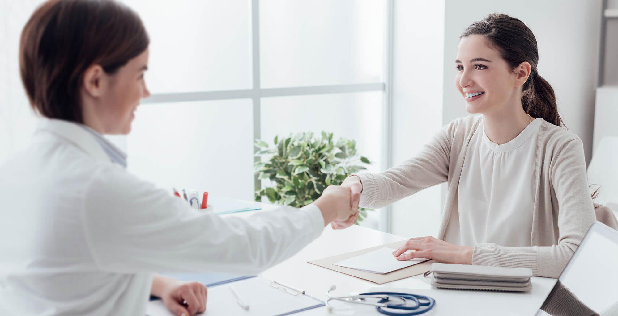 Family physician and patient shaking hands