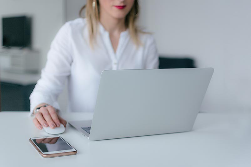 Woman browsing the internet on her laptop looking for a family doctor