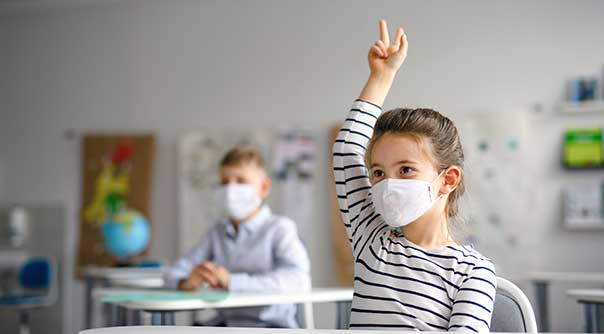 children learning at school during COVID-19 with face masks