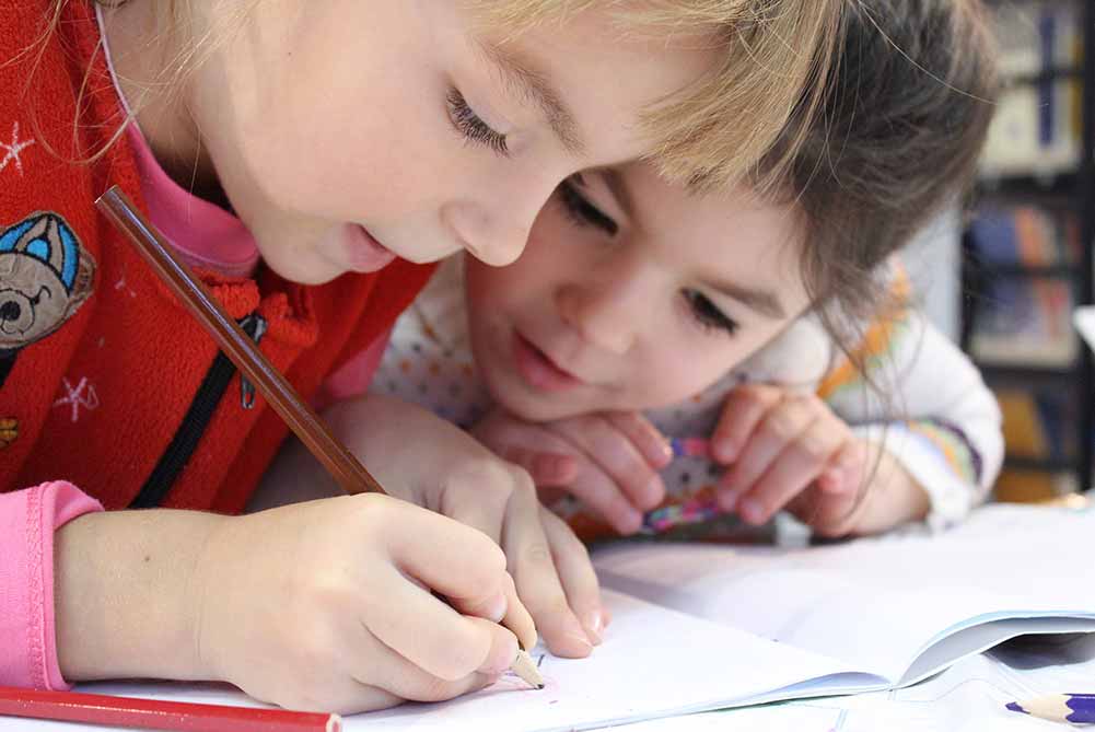 children writing and reading at school