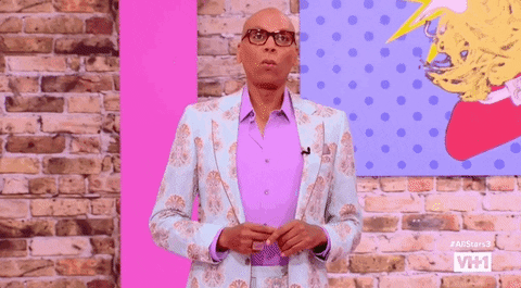 GIF of Rupaul yelling "Wait a minute" in a shocked way.