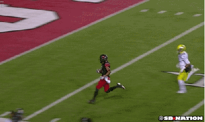 GIF of a football player, with no opposing player around, about to score a touchdown only to drop the football just before scoring.