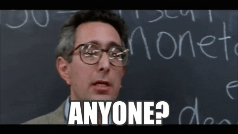 GIF of a teacher standing in front of the chalkboard asking the class "Anyone?"