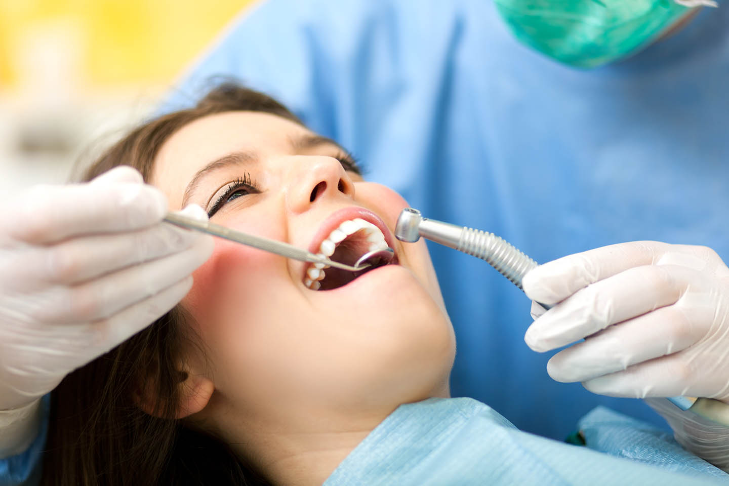 Young woman receiving teeth cleaning