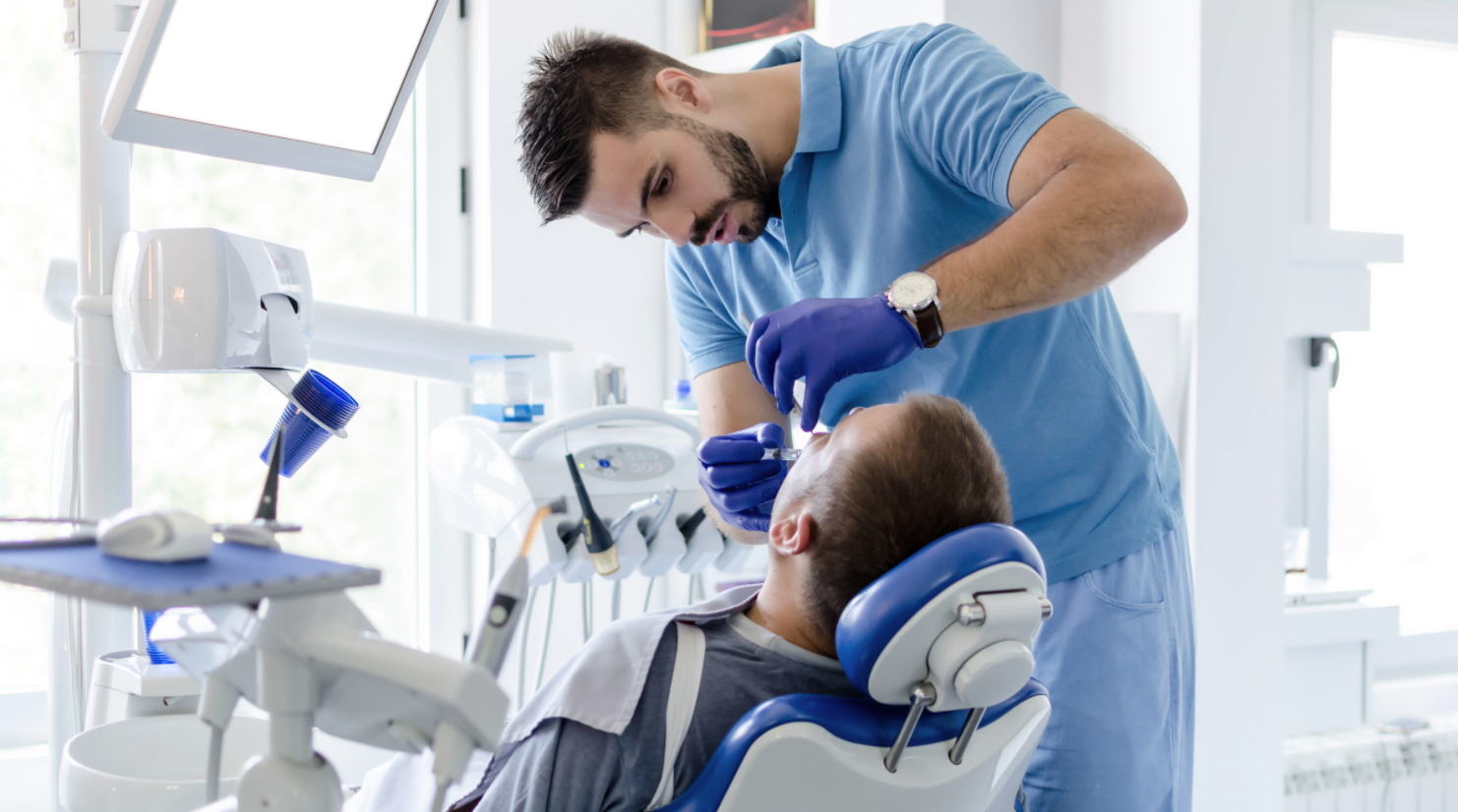 dentist doing dental work on man