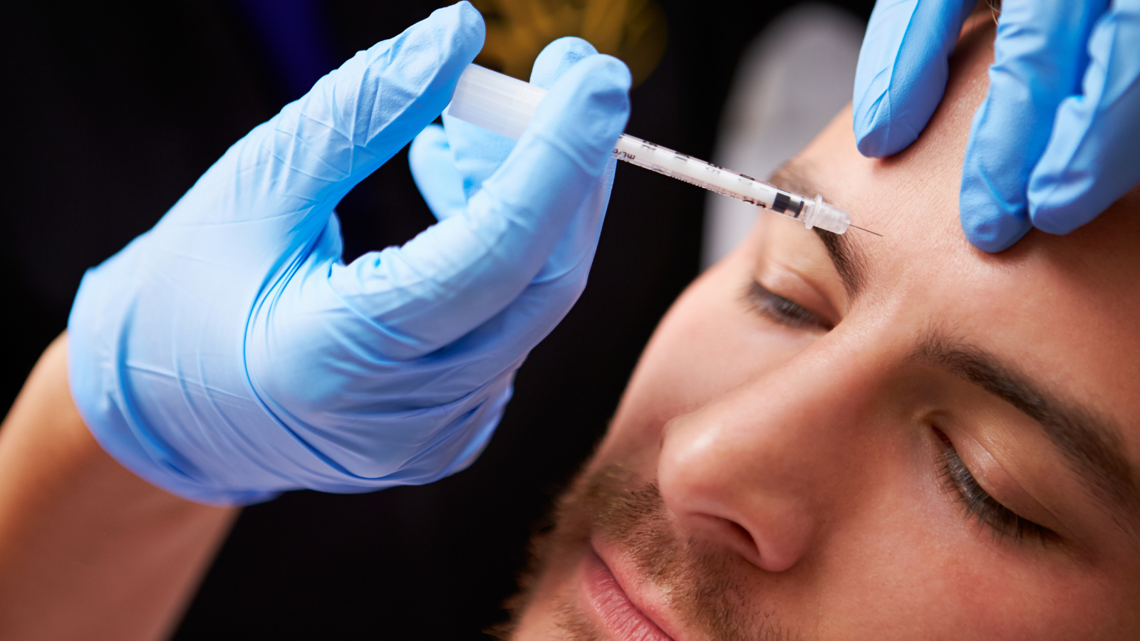 man getting botox injections