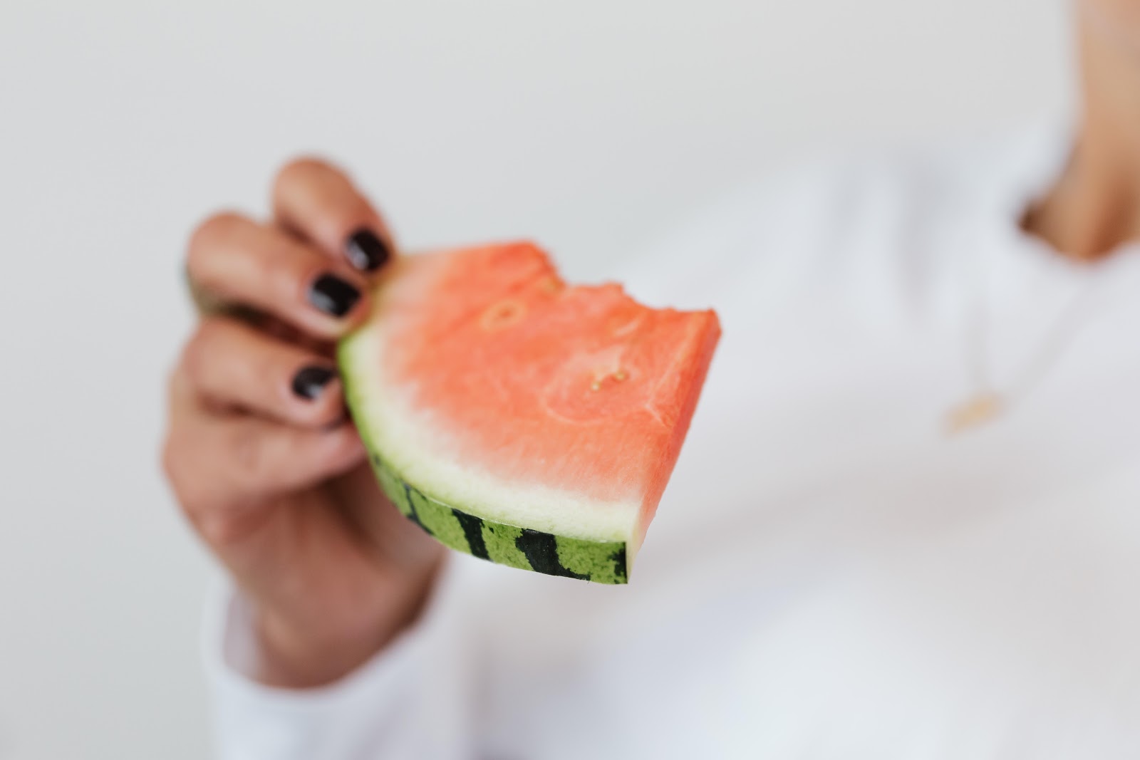 woman eating piece of watermelon