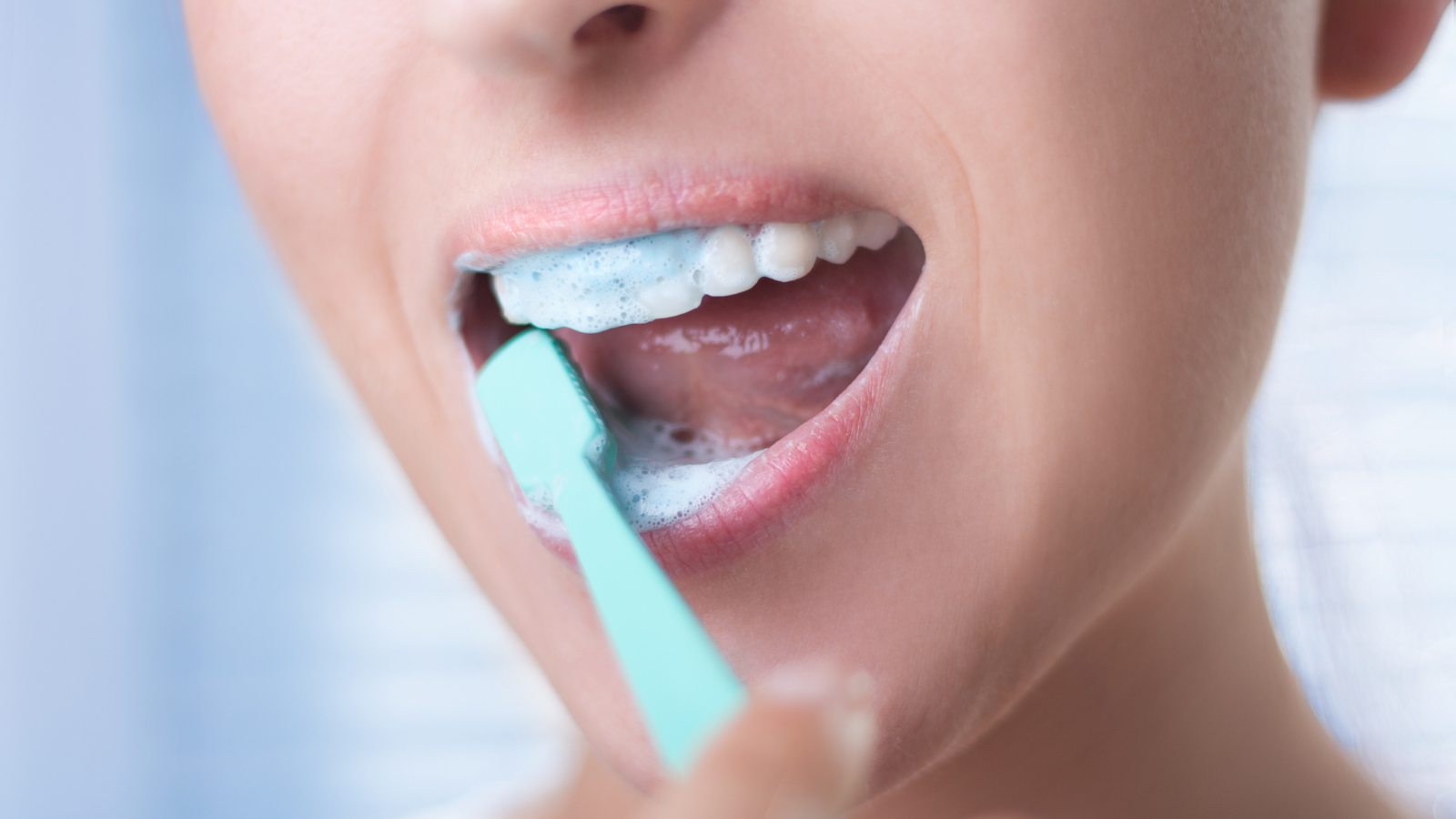 person brushing their teeth