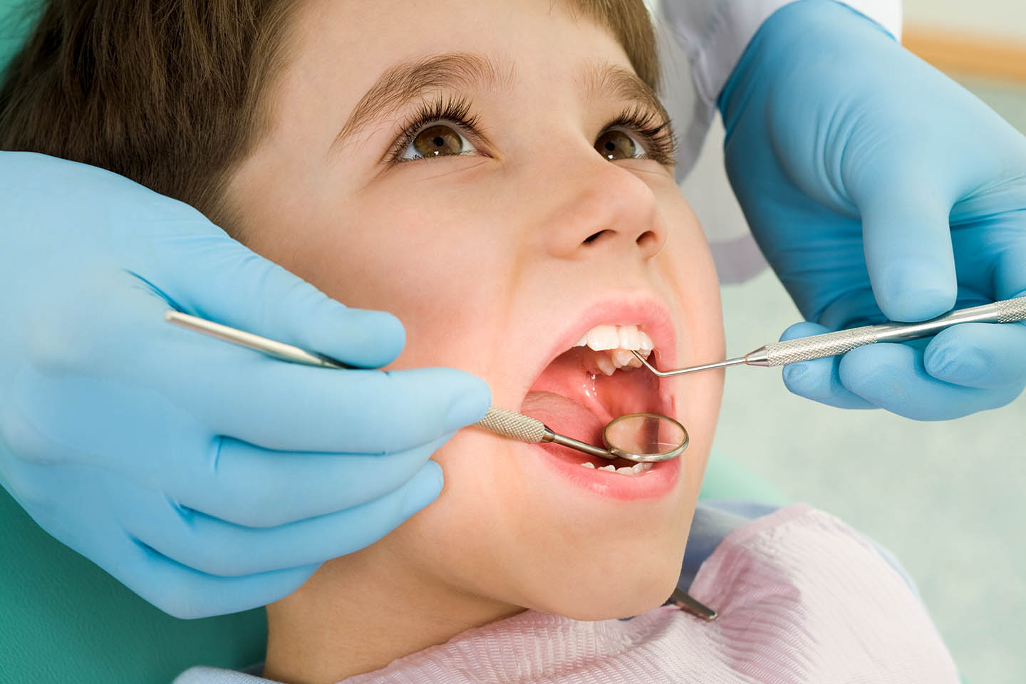 child sitting in dentist chair
