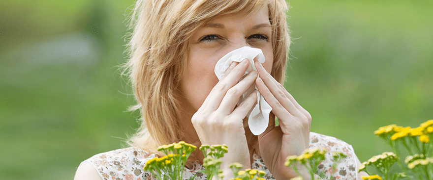 Allergy sufferer outdoors dealing with pollen triggers